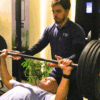 Treinador orientando treino personalizado com foco em recuperação muscular inteligente